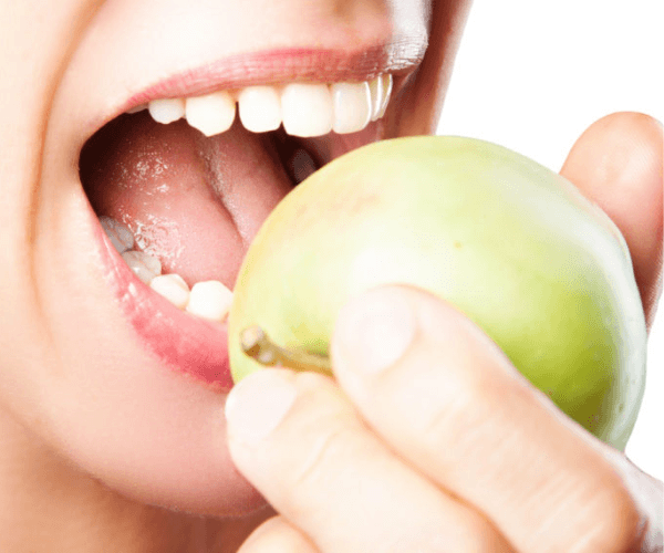 Woman biting into apple